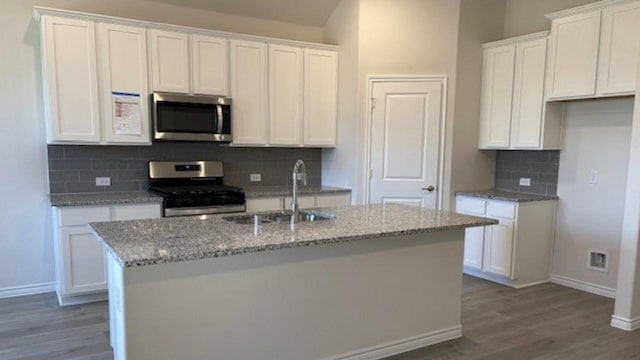 kitchen with white cabinets, appliances with stainless steel finishes, and sink