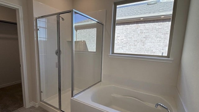 bathroom with independent shower and bath and tile patterned floors