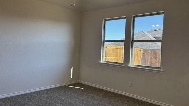 carpeted spare room featuring a healthy amount of sunlight