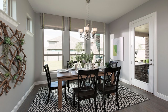 dining room with an inviting chandelier and dark hardwood / wood-style flooring