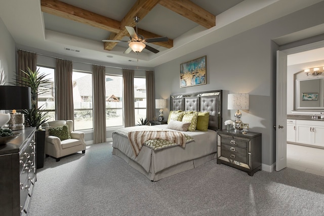 bedroom with ensuite bath, beamed ceiling, carpet floors, and ceiling fan