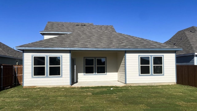 back of house featuring a yard