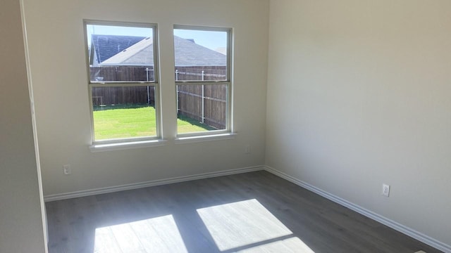 spare room featuring dark hardwood / wood-style flooring