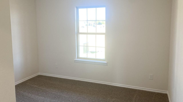 empty room with dark colored carpet