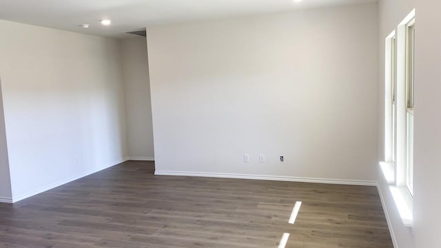 spare room featuring dark hardwood / wood-style flooring