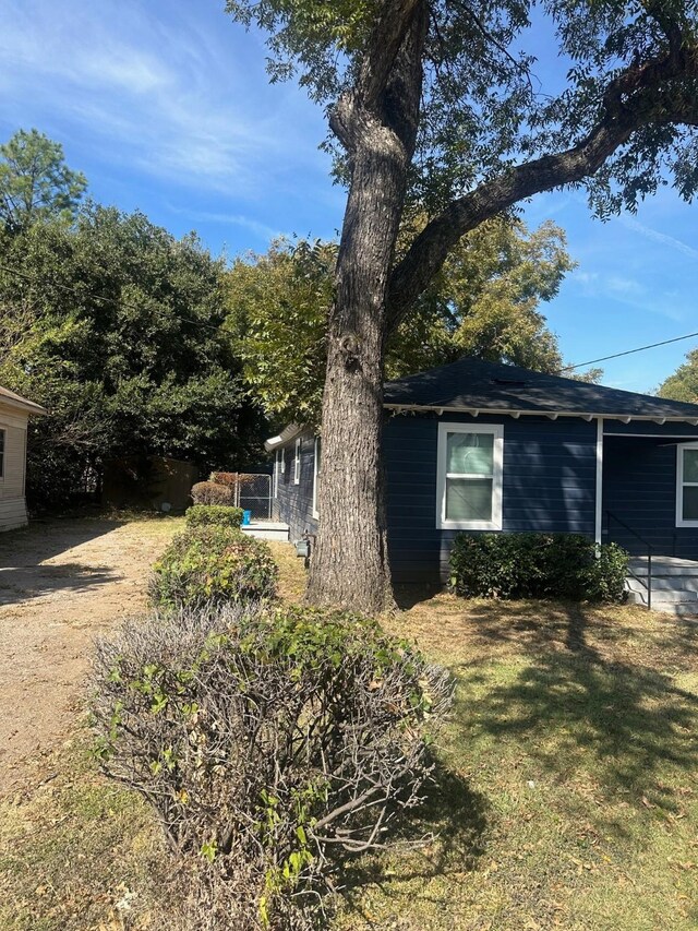 view of property exterior with a lawn