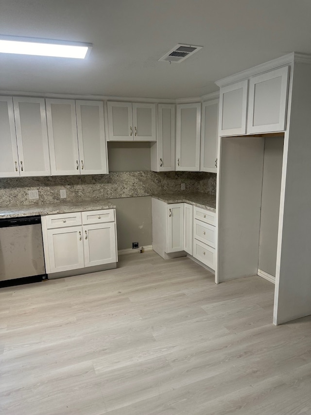 kitchen with white cabinetry, light wood-type flooring, tasteful backsplash, and stainless steel dishwasher