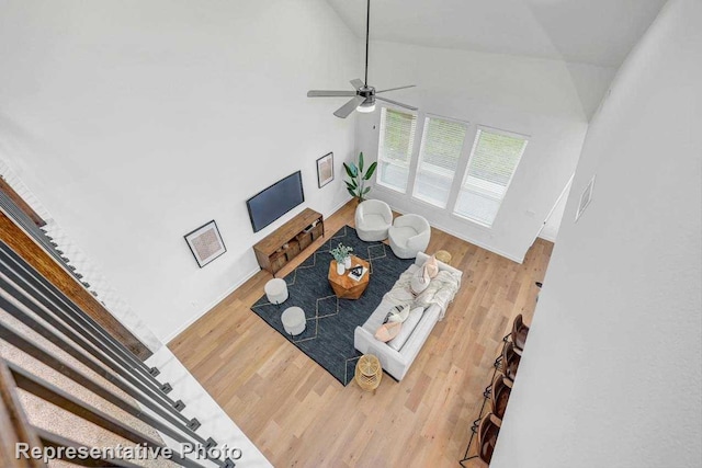 living room featuring high vaulted ceiling, wood-type flooring, and ceiling fan