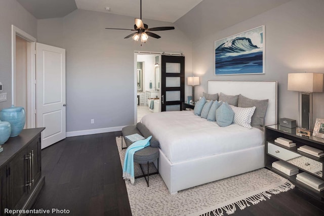 bedroom with ceiling fan, vaulted ceiling, ensuite bath, and dark hardwood / wood-style flooring