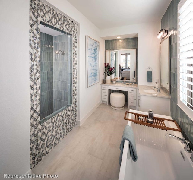 bathroom featuring vanity and separate shower and tub