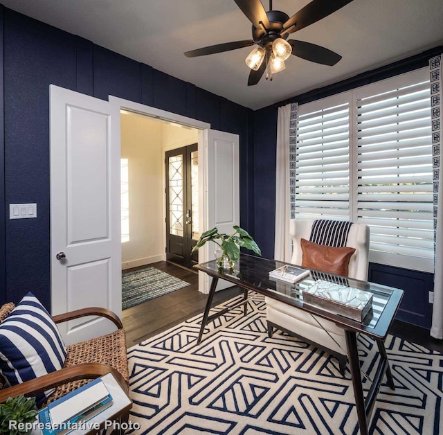 living area featuring french doors, wood-type flooring, and ceiling fan