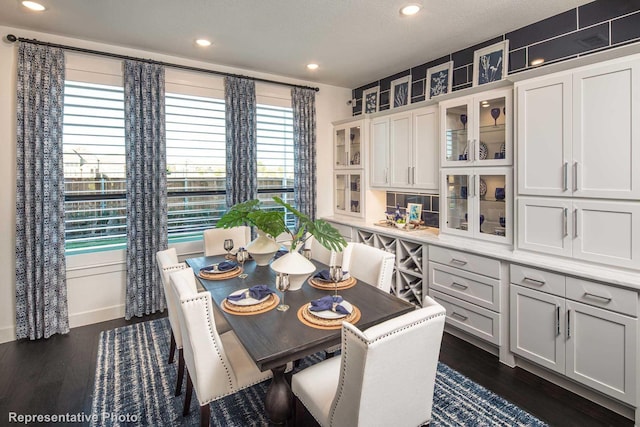 dining area with a textured ceiling, dark hardwood / wood-style floors, and plenty of natural light