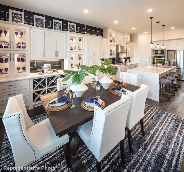 dining room featuring sink and dark hardwood / wood-style floors