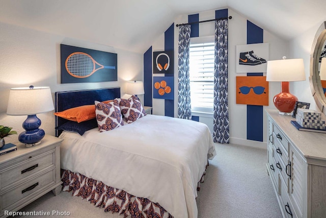 carpeted bedroom with lofted ceiling