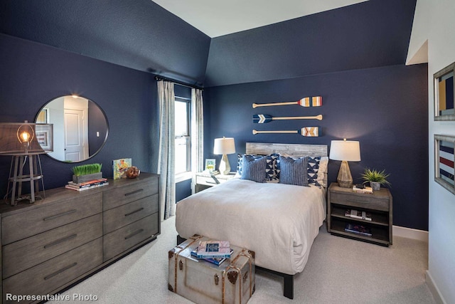 carpeted bedroom with vaulted ceiling