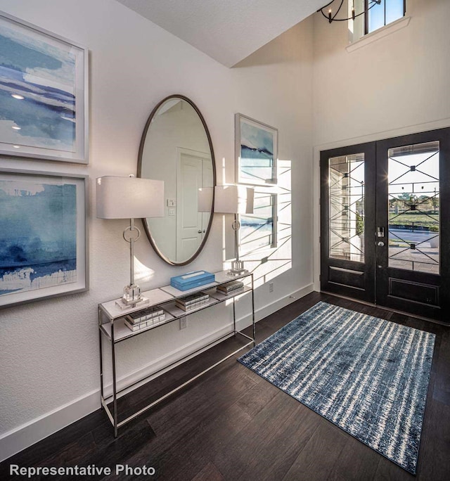 entryway with dark wood-type flooring and french doors