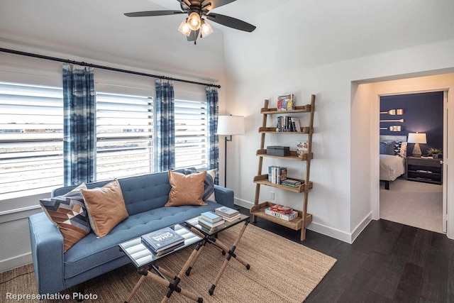 living room featuring dark wood-type flooring and ceiling fan