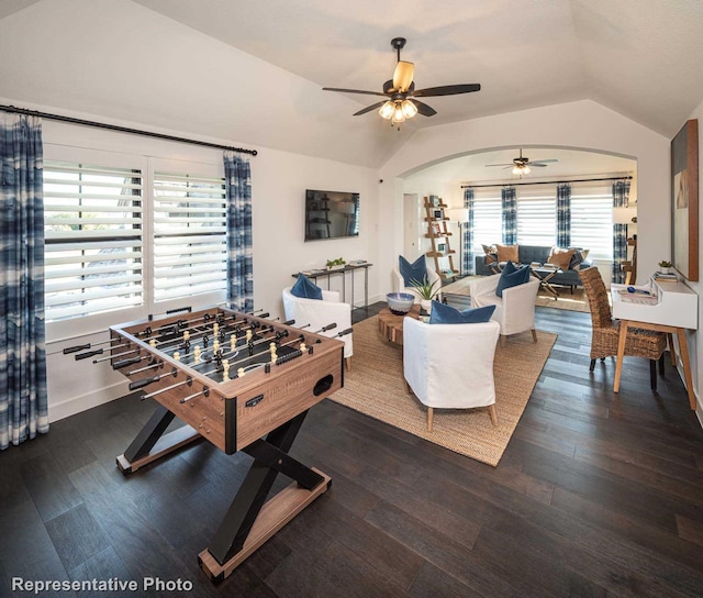 rec room with ceiling fan, lofted ceiling, and dark hardwood / wood-style floors