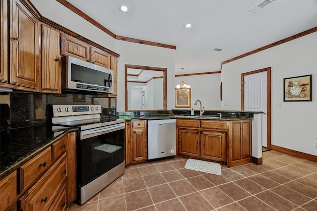 kitchen featuring dark tile patterned flooring, tasteful backsplash, stainless steel appliances, crown molding, and a chandelier