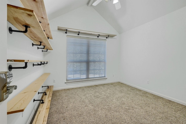 spare room with ceiling fan, vaulted ceiling, and carpet floors