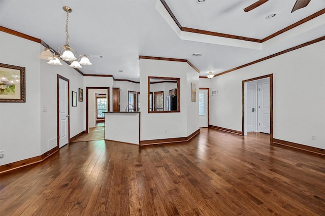 unfurnished living room featuring dark wood-type flooring, crown molding, and ceiling fan with notable chandelier