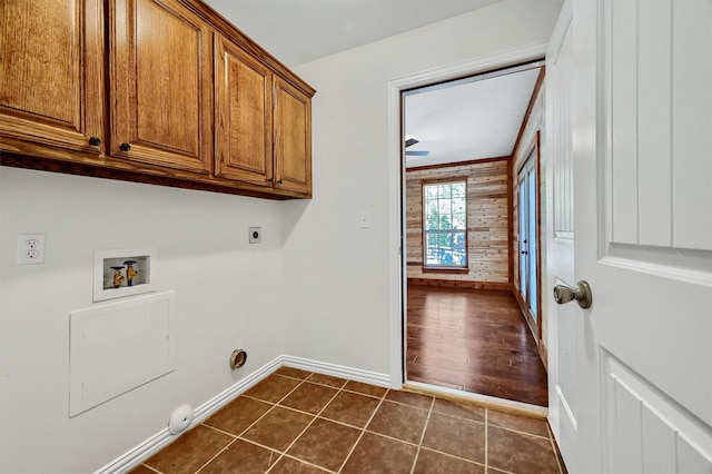 laundry area with dark tile patterned flooring, hookup for a washing machine, hookup for an electric dryer, cabinets, and ceiling fan