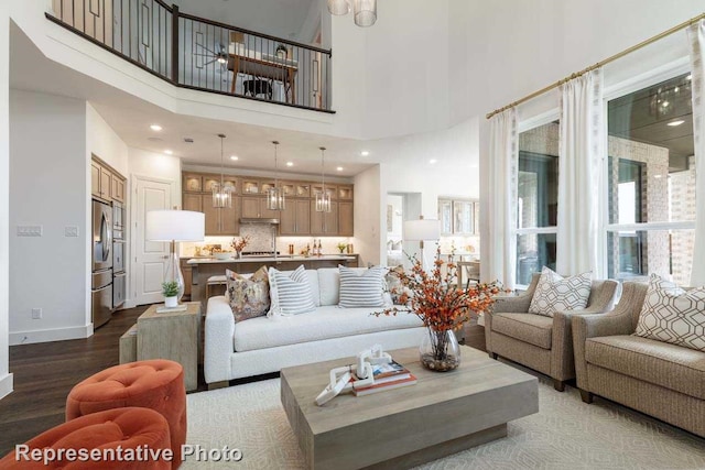 living room featuring hardwood / wood-style floors and a high ceiling