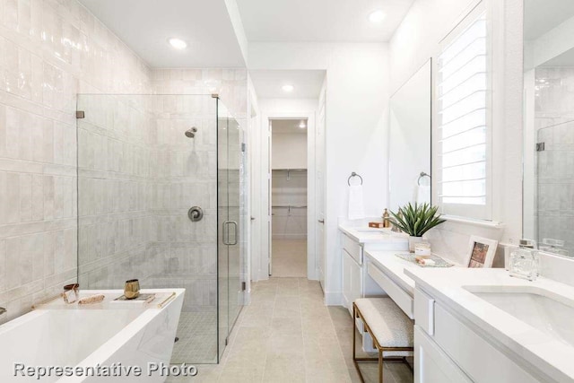 bathroom with vanity, independent shower and bath, and tile patterned flooring