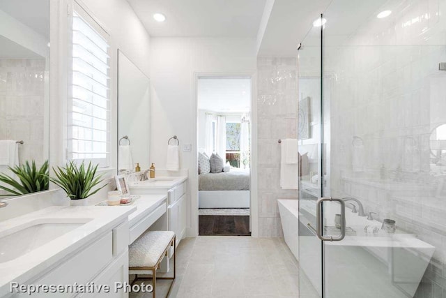 bathroom featuring vanity, tile patterned floors, and shower with separate bathtub