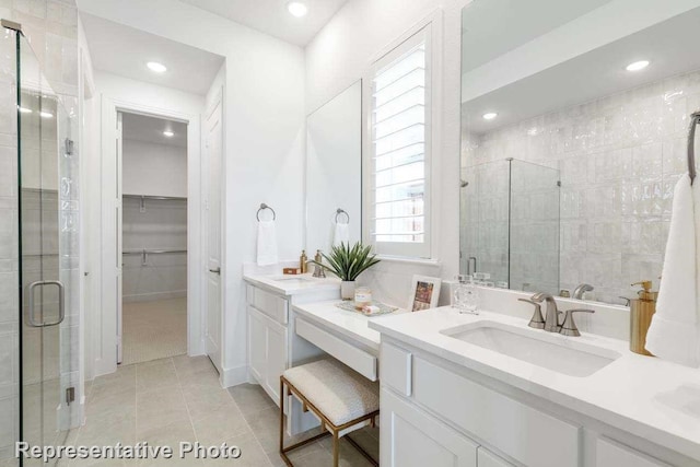 bathroom featuring vanity, an enclosed shower, and tile patterned floors