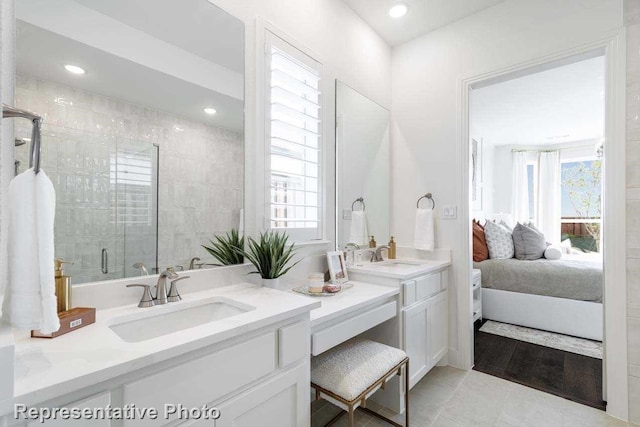 bathroom featuring vanity, tile patterned floors, a wealth of natural light, and an enclosed shower