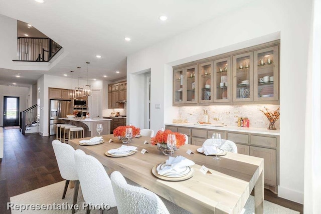 dining area featuring dark hardwood / wood-style floors and an inviting chandelier