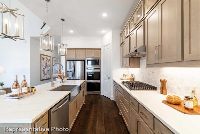 kitchen with dark hardwood / wood-style flooring, a large island, stainless steel appliances, pendant lighting, and a chandelier