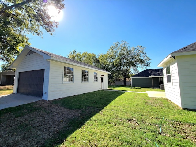 view of yard with cooling unit and a garage