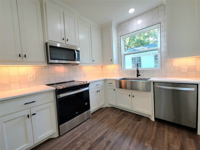 kitchen with white cabinets, stainless steel appliances, dark wood-type flooring, and sink