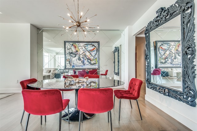 dining area featuring hardwood / wood-style floors and a chandelier