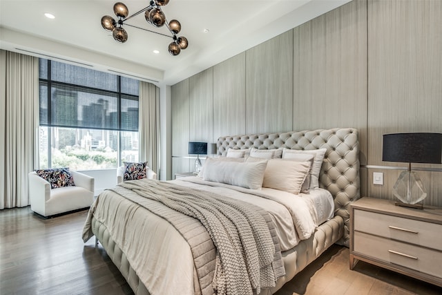 bedroom featuring wood-type flooring and a chandelier