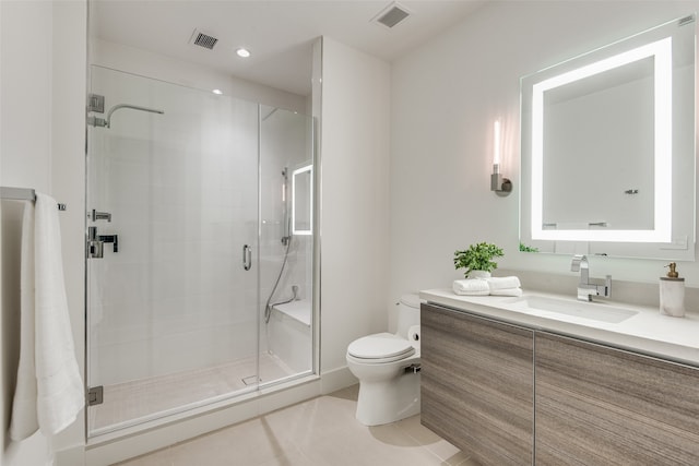 bathroom featuring vanity, a shower with shower door, toilet, and tile patterned flooring