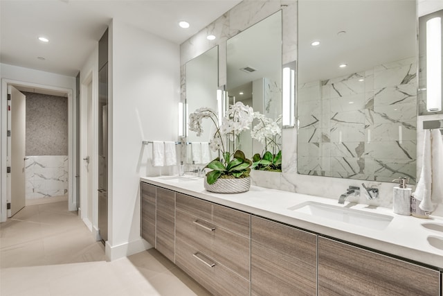 bathroom featuring vanity, tile patterned floors, and tiled shower