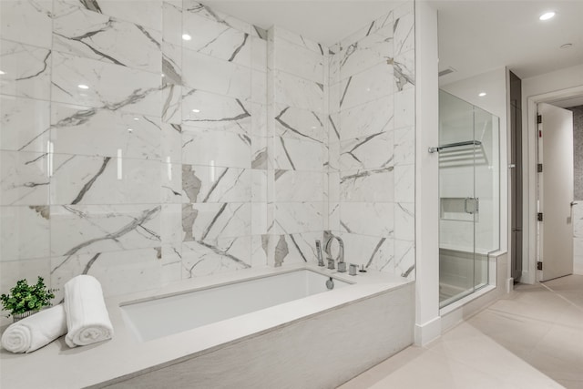 bathroom with tile walls and plus walk in shower