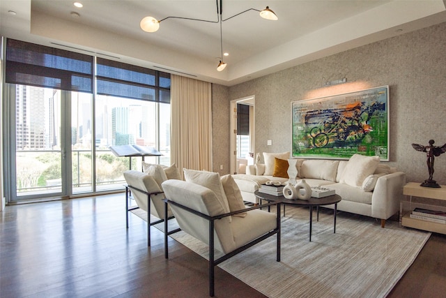 living room featuring hardwood / wood-style flooring, a wealth of natural light, and a wall of windows