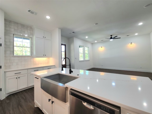 kitchen featuring dark hardwood / wood-style flooring, dishwasher, white cabinets, and a wealth of natural light