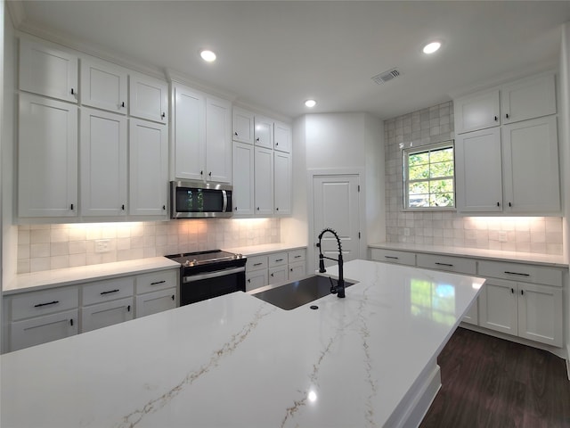 kitchen featuring range with electric stovetop, white cabinetry, light stone countertops, dark wood-type flooring, and sink