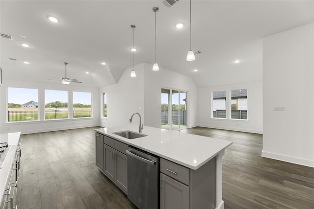 kitchen featuring stainless steel dishwasher, sink, vaulted ceiling, and gray cabinetry