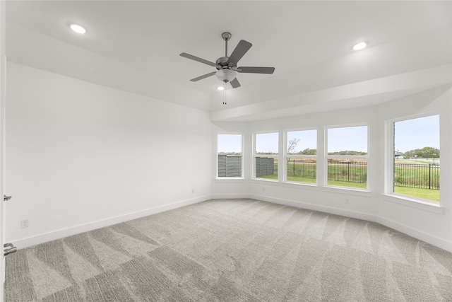 spare room featuring carpet flooring and ceiling fan