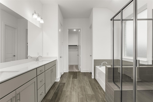 bathroom with vanity, plus walk in shower, and hardwood / wood-style floors