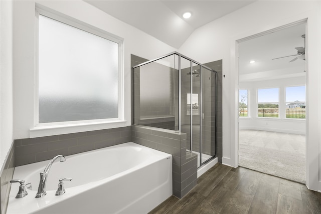 bathroom with independent shower and bath, vaulted ceiling, and hardwood / wood-style flooring