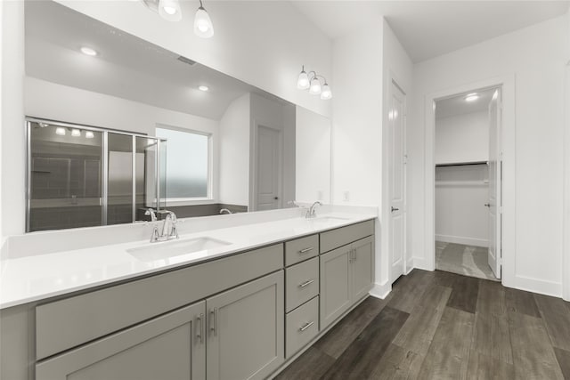 bathroom featuring vanity, wood-type flooring, and an enclosed shower