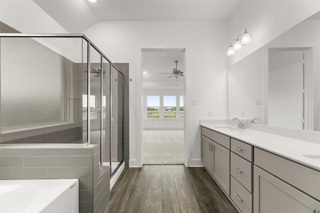 bathroom featuring vanity, independent shower and bath, wood-type flooring, and ceiling fan