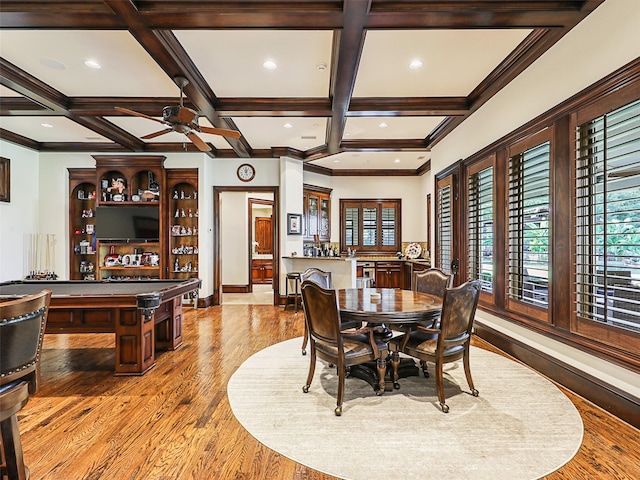 dining space featuring beamed ceiling, coffered ceiling, light wood-type flooring, and ceiling fan